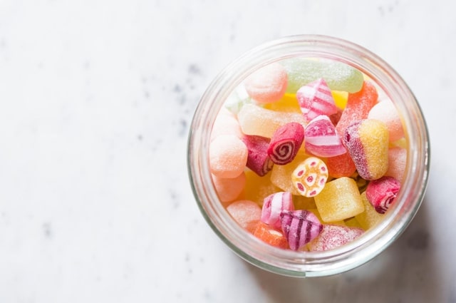 9 Tips to Make Your Wedding More Eco-Friendly, a jar filled with candy.