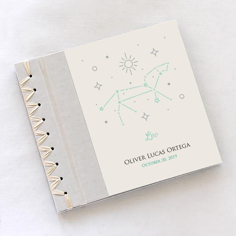 18 Sweet Baby Memory Books to Add to Your Registry, Baby’s First Book with Zodiac Cover
